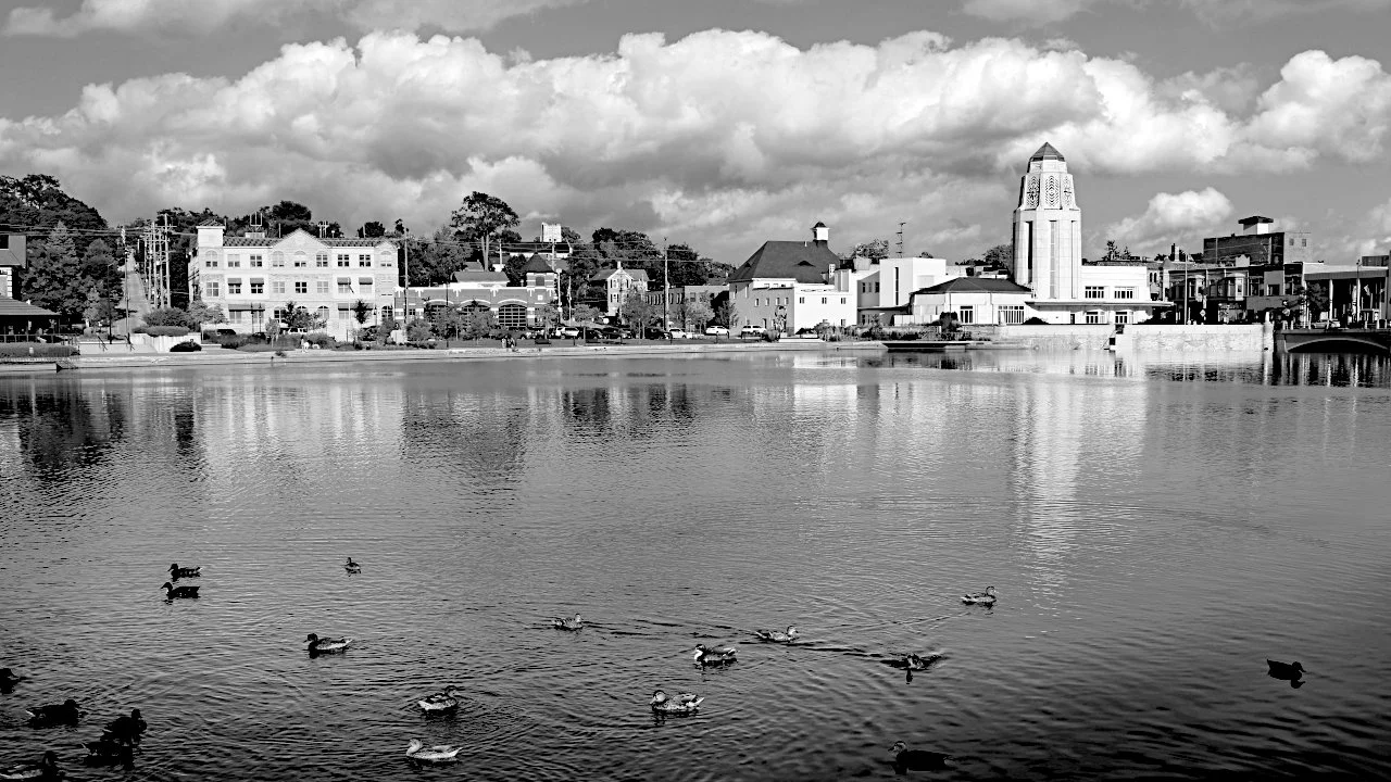 Riverfront town architecture reflected in calm water